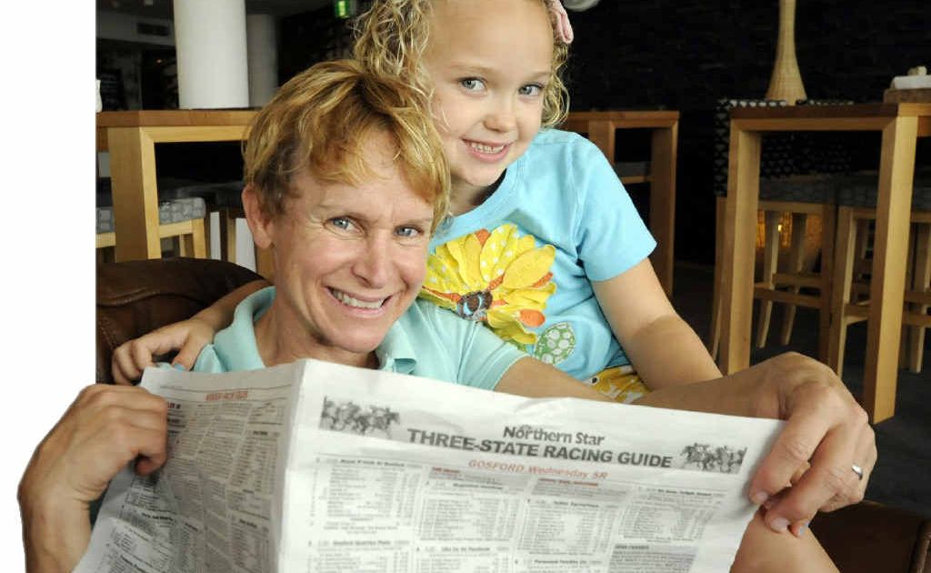 Jockey Julie Krone, with her six-year-old daughter Lorelei, check out the form guide after arriving in Ballina. Jockey Julie Krone, with her six-year-old daughter Lorelei, check out the form guide after arriving in Ballina.